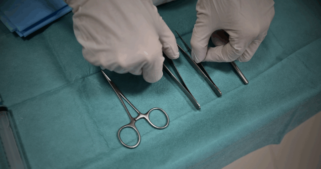 Gloved medical examiner holding forensic tool – from Kenzie Kirsch thriller