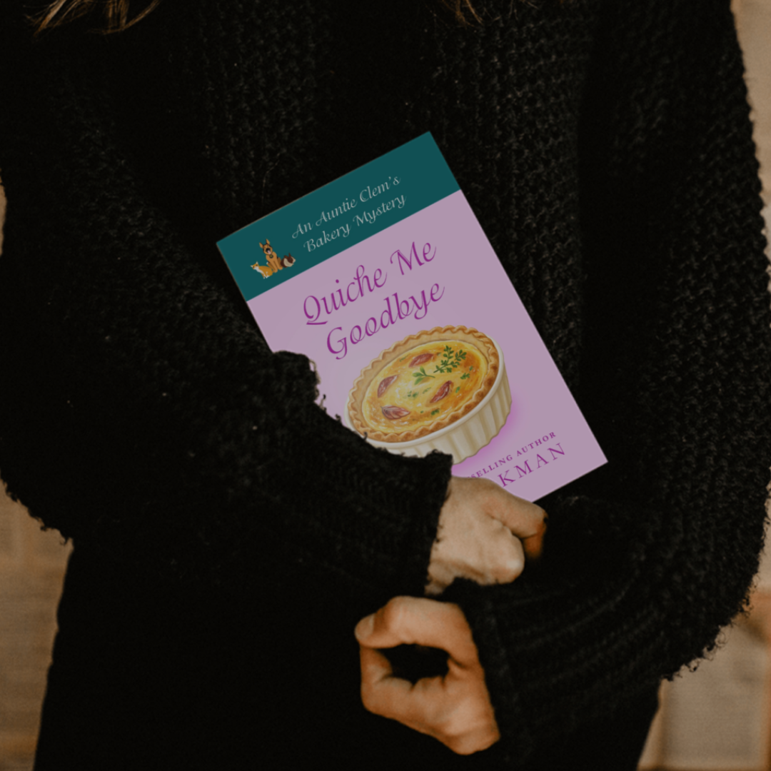 Figure holding a copy of Quiche Me Goodbye