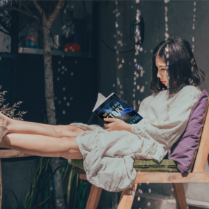 woman immersed in reading They Sold Her Story, a Zachary Goldman standalone mystery